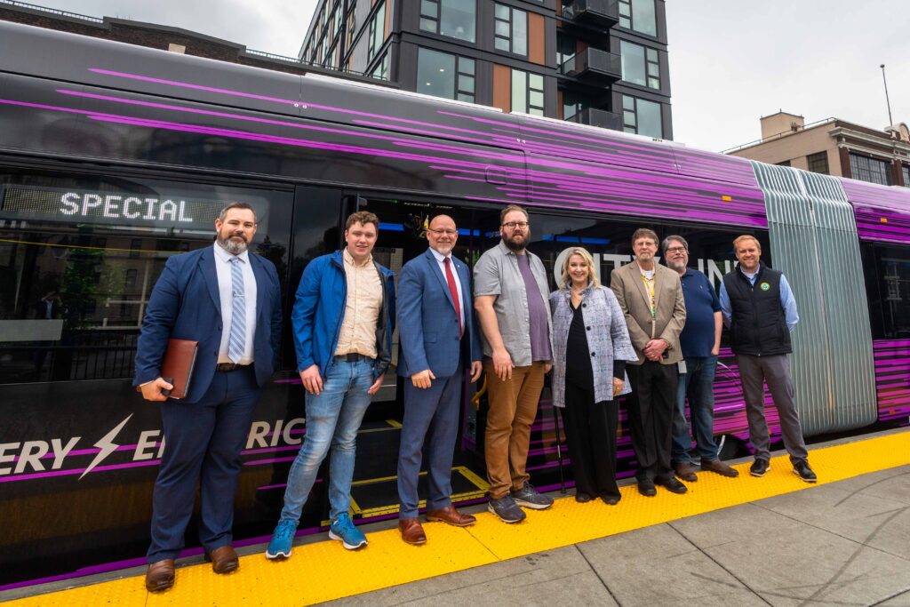 Senator Liias standing in front of a City Line Bus with STA leadership