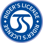 A circular blue logo featuring a white stylized road design at its center. The words "Rider's License" encircle it in white, separated by small white diamonds, and the logo has a thin grey outline. This emblem signifies STA Reduced Fare Pass qualifications for eligible riders.