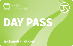 A green Spokane Transit day pass card featuring a bus icon, a series of small arrows, and the Spokane Transit logo in the top right corner is part of the STA Community Access Program. The text "DAY PASS" is prominently displayed, with "spokanetransit.com" at the bottom.