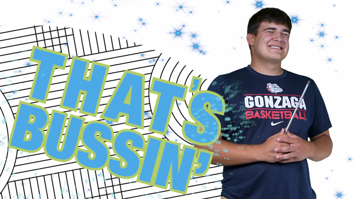 A person wearing a "Gonzaga Basketball" shirt stands smiling with eyes closed. The background features a starry, abstract design with blue and white lines. The phrase "THAT'S BUSSIN'" is prominently displayed in bold letters.