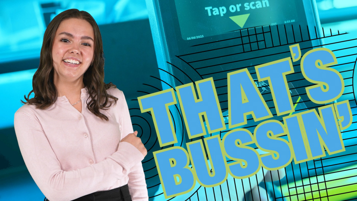 A young woman with long brown hair smiles and gestures with her right hand. She is wearing a light pink blouse and stands next to large text that says "THAT'S BUSSIN'." A blue background with a card reader is behind her.