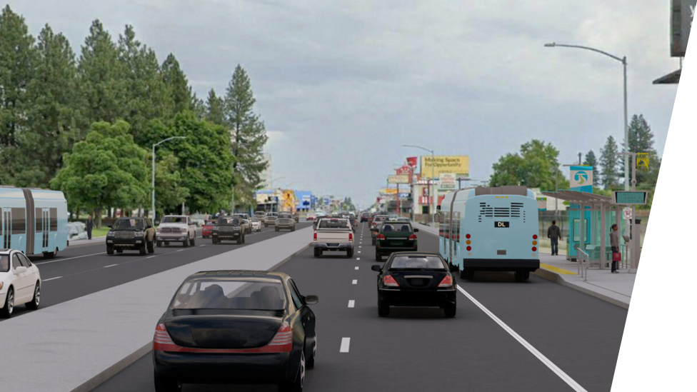 A busy urban street with multiple lanes of traffic, including buses, cars, and a light rail. There are trees and buildings on both sides, and the sky is overcast. A bus stop with people waiting is visible on the right, alongside a billboard and streetlights.