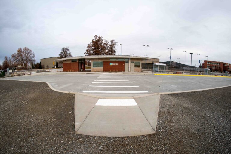 A small, single-story building with a crosswalk in front, set against a cloudy sky, stands as a testament to community support from the Section 5310 Program.