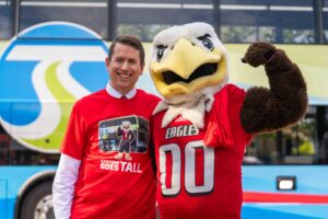 STA CEO Karl Otterstrom poses with Swoop, EWU's mascot.