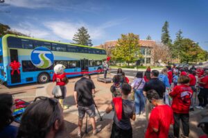 A wide shot from a different angle of the event from the back of the crowd.