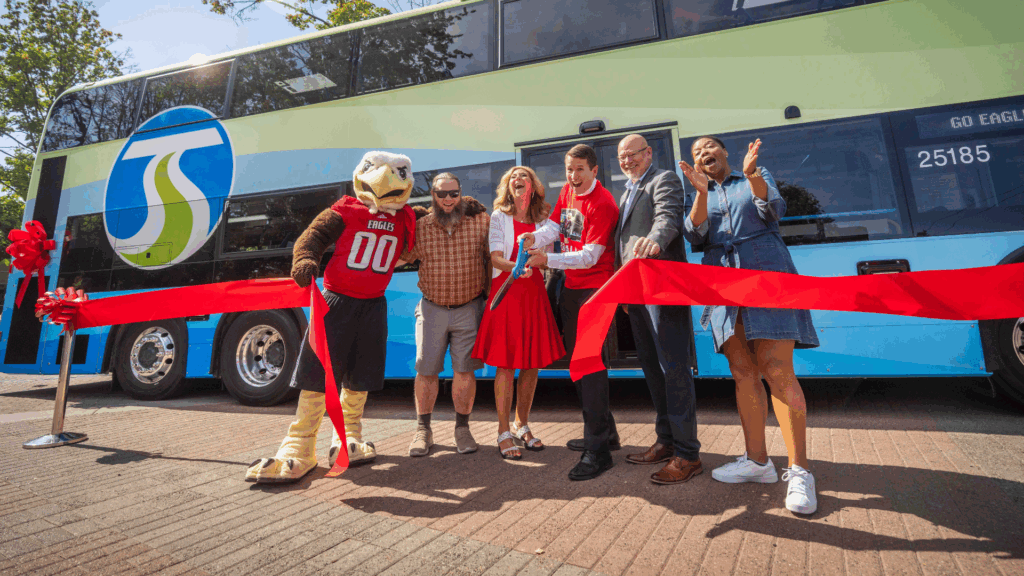 EWU mascot Swoop, City of Medical Lake Council Member and STA Board Member Lance Speirs, EWU President Shari McMahan, STA CEO Karl Otterstrom, City of Cheney Mayor and STA Board Member Chris Grover, and City of Spokane Council President and STA Board Member Besty Wilkerson cut the red ribbon to officially kick off double-decker service.