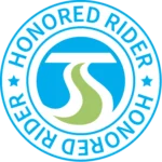 Circular "Honored Rider" logo featuring a green road and blue arch at the center.