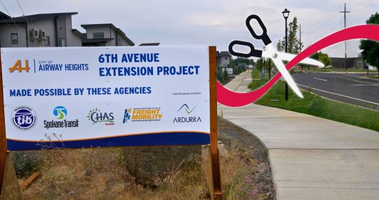 6th Avenue Extension Project sign by a road with digitally added scissors and ribbon.